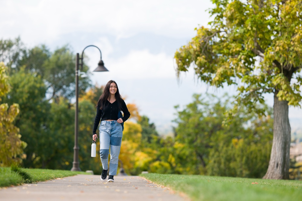 Student walking in the fall